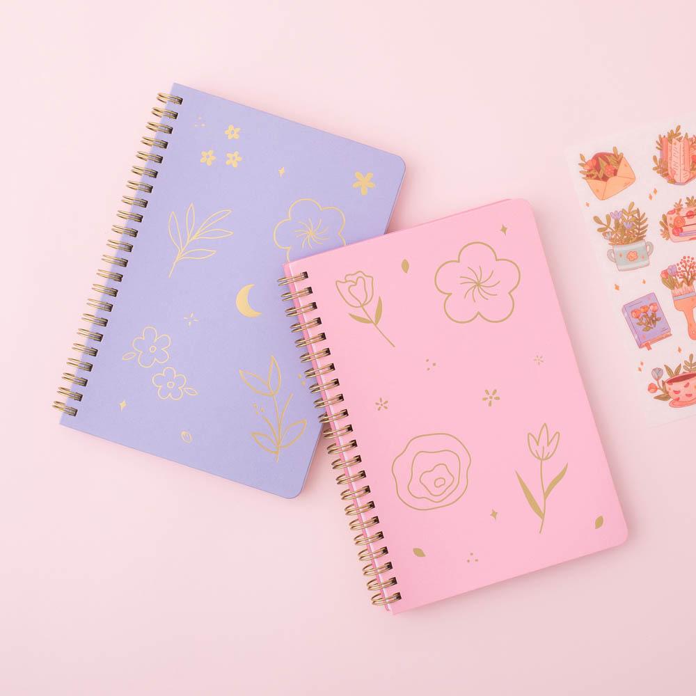 Sakura Pink and lilac taro Tsuki Floral ringbound bullet journal with free sticker sheet on pink background