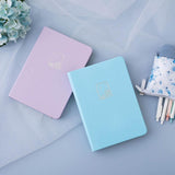 Tsuki Endless Summer Limited Edition Bullet Journals in Lilac Bloom and Petal Blue with netting and Tsuki Endless Summer Pop-Up Pencil case and light blue hydrangea flowers on light blue background