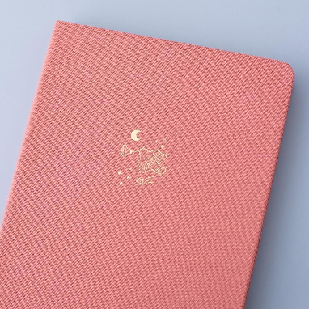 Close up of the front cover of Tsuki ‘Suzume’ Limited Edition Bullet Journal on lilac background