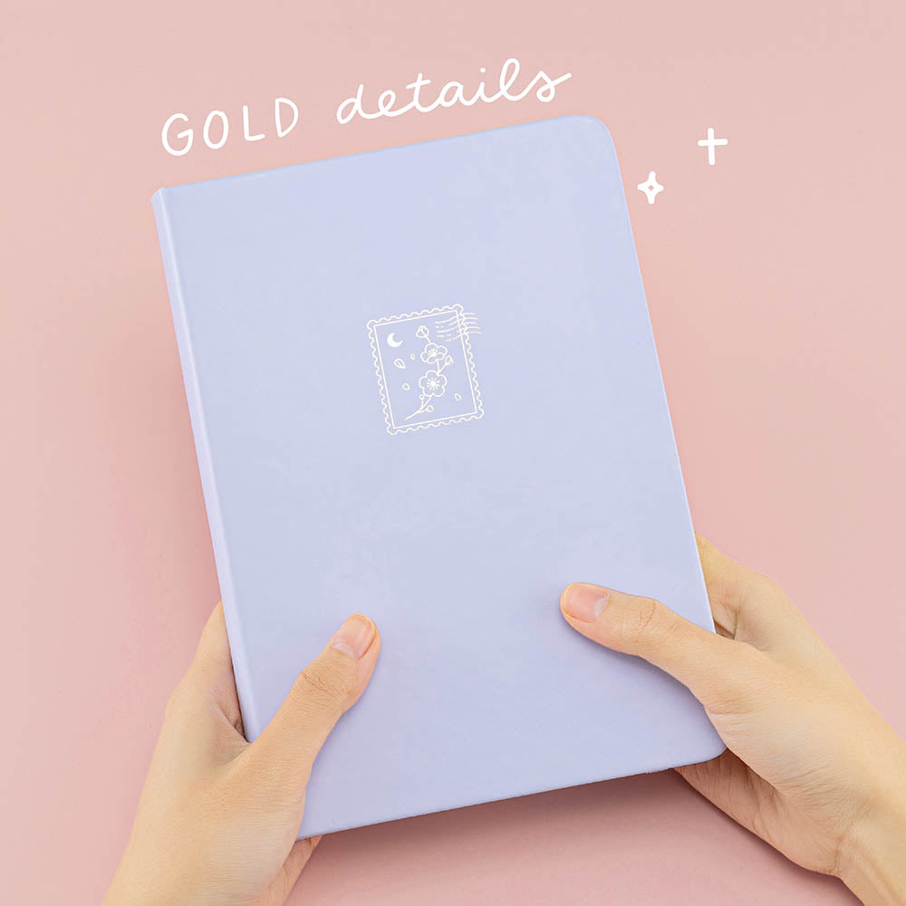 Tsuki ‘Sakura Journey’ Limited Edition Bullet Journal held in hands in pink background