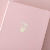 Close up of the front cover of Tsuki ‘Ichigo’ Limited Edition Boba Bullet Journal on light pink background