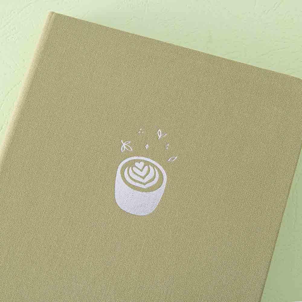 Close up of the front cover of Tsuki ‘Matcha Matcha’ Limited Edition Bullet Journal on matcha green background