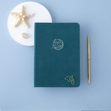 Tsuki sea green velvet Dolphin Days notebook with starfish and gold pen and free dolphin gift on blue background