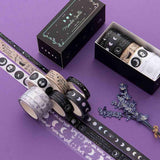 Tsuki ‘Moonlit Spell’ Washi Tapes rolled out with lavender sprigs on purple background