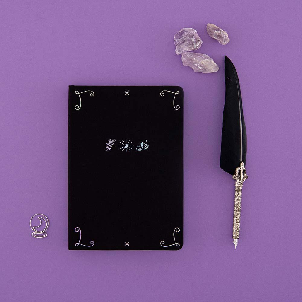 Tsuki ‘Moonlit Spell’ Limited Edition Holographic Bullet Journal with free bookmark gift with black feather quill and amethyst stones on purple background