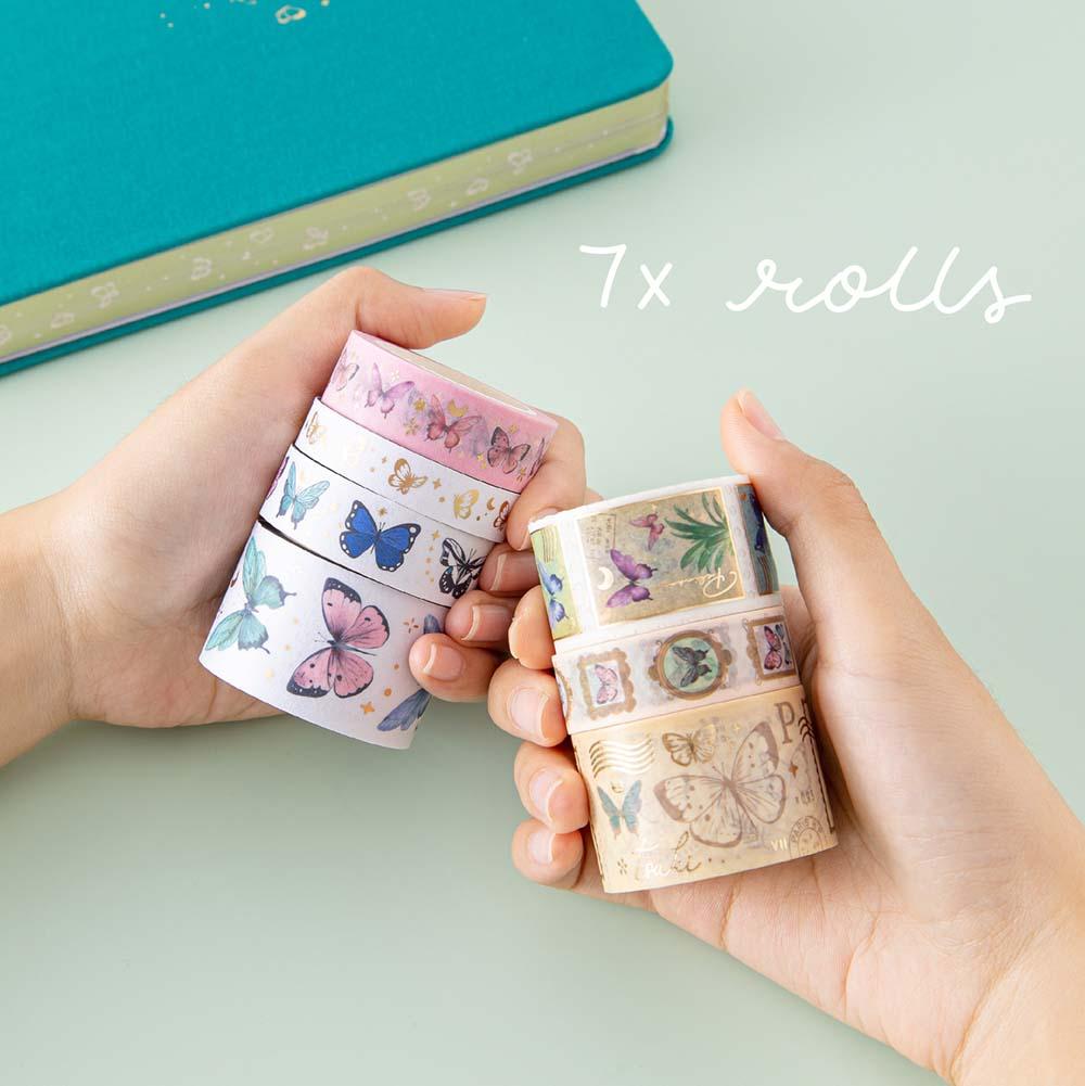 Tsuki ‘Flutter + Dream’ Washi Tape Set by Notebook Therapy x Pelinkan held in hands with Tsuki Teal Sky ‘Flutter + Dream’ Limited Edition Bullet Journal by Notebook Therapy x Pelinkan on mint background