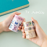 Tsuki ‘Flutter + Dream’ Washi Tape Set by Notebook Therapy x Pelinkan held in hands with Tsuki Teal Sky ‘Flutter + Dream’ Limited Edition Bullet Journal by Notebook Therapy x Pelinkan on mint background