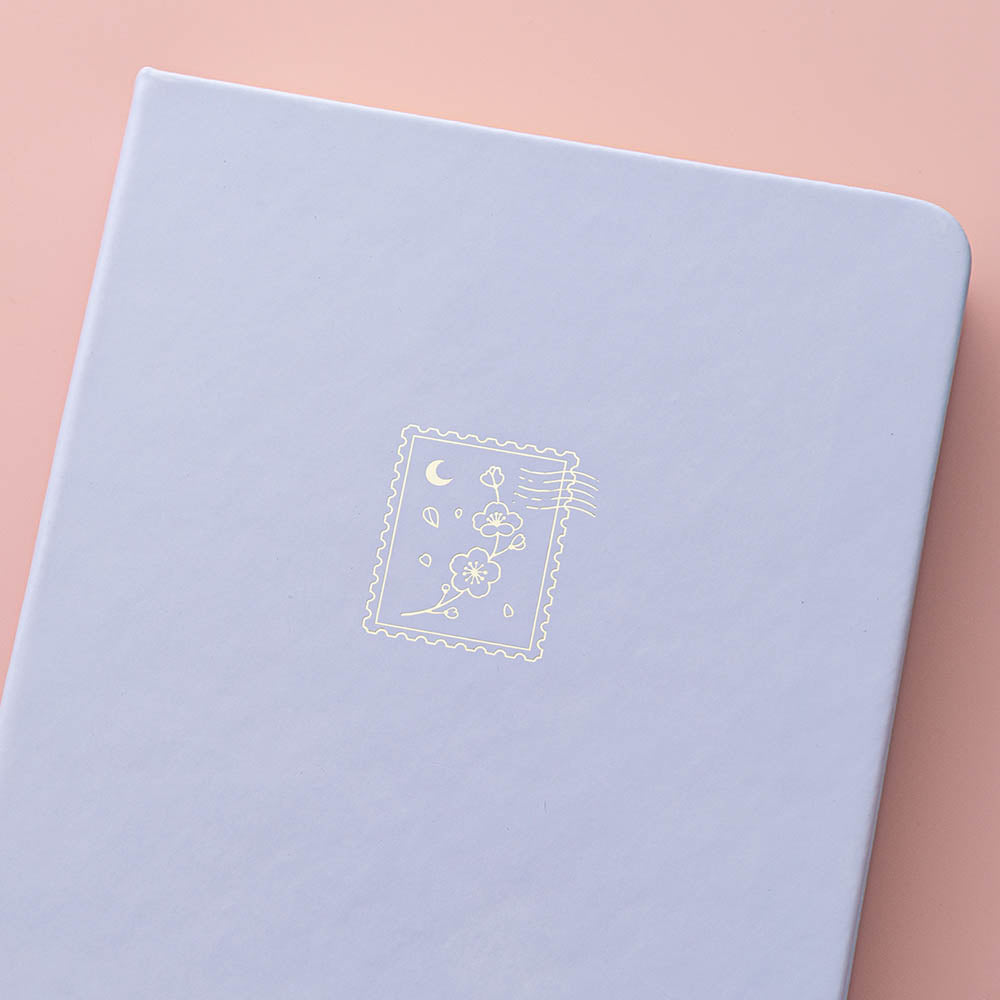Close up of the cover design of Tsuki ‘Sakura Journey’ Limited Edition Bullet Journal on pink background