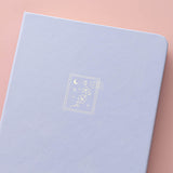 Close up of the cover design of Tsuki ‘Sakura Journey’ Limited Edition Bullet Journal on pink background