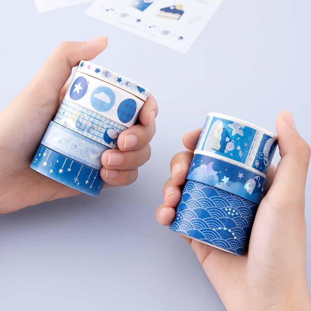 Close up of Tsuki ‘Cup of Galaxy’ Washi Tapes held in hands in light blue background