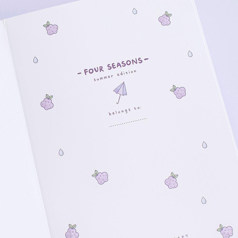 Close up of open front page of Tsuki Four Seasons: Summer Edition Bullet Journal designed with @milkkoyo on lilac background