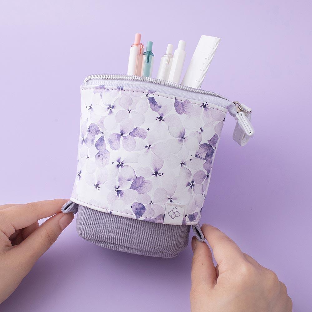 Tsuki Endless Summer Pop-Up Pencil case in Lilac Bloom held in hands on lilac background