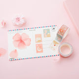 Tsuki 'Sakura Edition' Washi Petal Sticker and Stamp Tape on postcard with sakura blooms on light pink background