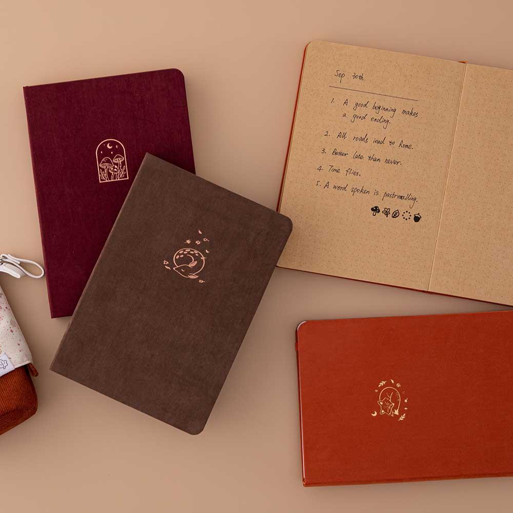 Tsuki Kraft Paper Limited Edition Bullet Journals in Kitsune and Kinoko and Nara with Tsuki ‘Maple Dreams’ Pop Up Pencil Case in maple and open kraft paper bullet journal pages on beige background