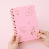 Tsuki sakura pink floral ringbound notebook held in hands in pink background