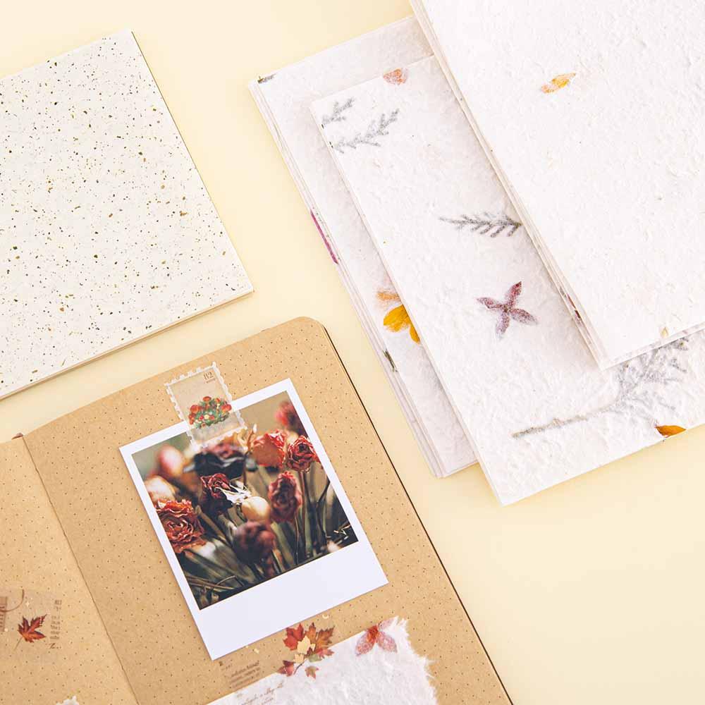 Tsuki Handmade Petal Paper Pack with polaroid picture on open Tsuki Kraft Paper Limited Edition Bullet Journal and Tsuki Mixed Scrapbook Paper on cream background