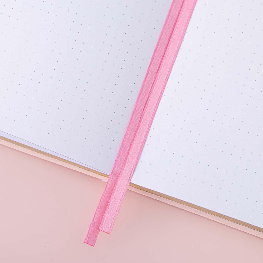 Close up of open pages and two bookmark ribbons of Tsuki ‘Ichigo’ Limited Edition Boba Bullet Journal on light pink background
