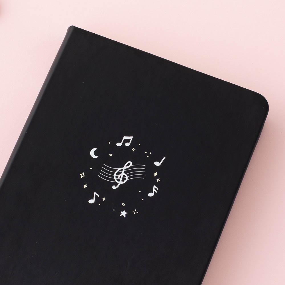 Close up of Tsuki Lunar Notes bullet journal front cover design image on pink background