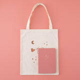 Tsuki ‘Moonflower’ Limited Edition Tote Bag with ‘Suzume’ Limited Edition Bullet Journal on coral pink background