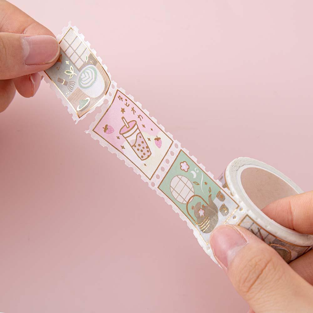 Tsuki ‘Matcha Ichigo’ Washi stamp tape held in hands in light pink background