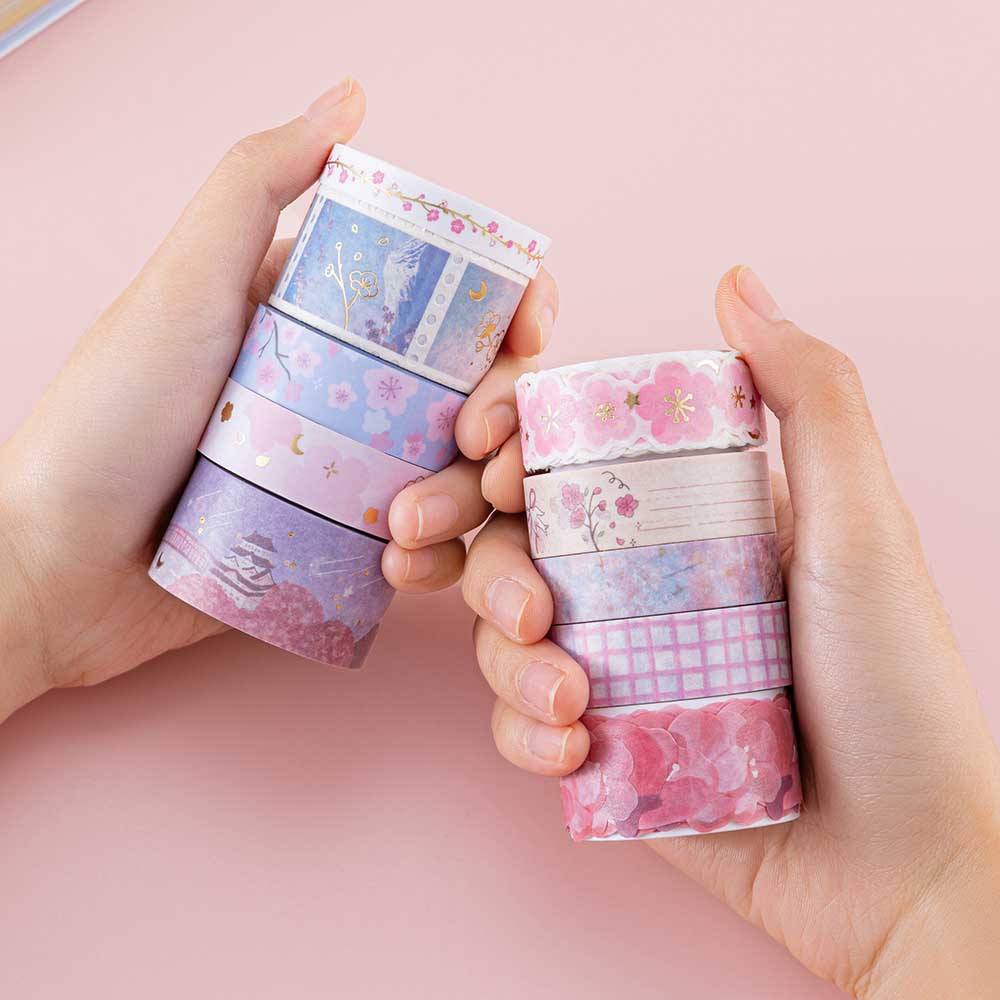 Tsuki ‘Sakura Journey’ Washi Tape Set held in hands in light pink background