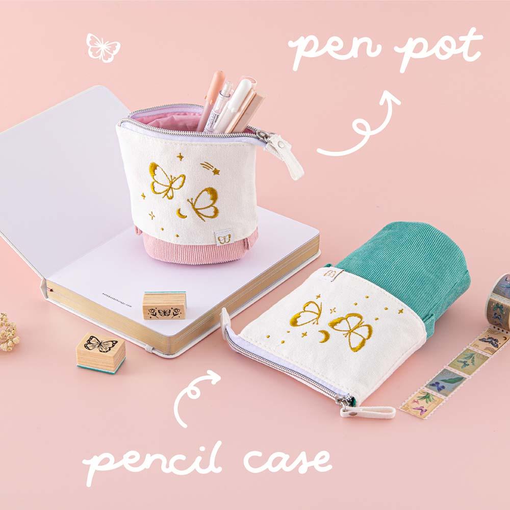Tsuki ‘Flutter + Dream’ Pop-Up Pencil Cases by Notebook Therapy x Pelinkan in teal and pastel pink on open Tsuki Cloud White ‘Flutter + Dream’ Limited Edition Bullet Journal by Notebook Therapy x Pelinkan with Tsuki ‘Flutter + Dream’ Washi Tapes by Notebook Therapy x Pelinkan and Tsuki ‘Flutter + Dream’ Bullet Journal Stamps by Notebook Therapy x Pelinkan on pastel pink background