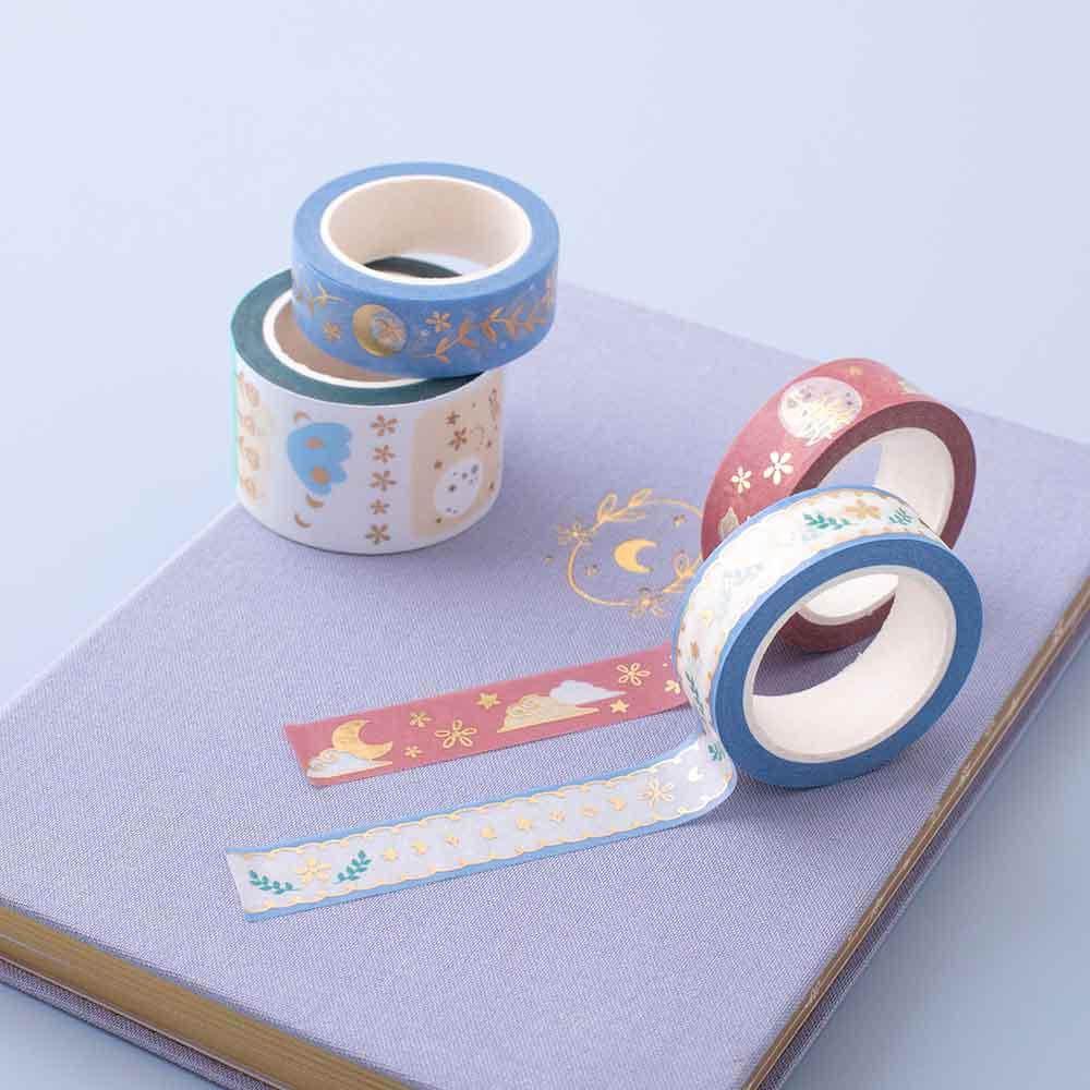 Close up of Tsuki ‘Moonflower’ Washi Stamp Tape Set with Tsuki ‘Full Bloom’ Limited Edition Bullet Journal on dusty blue background