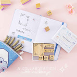 Tsuki ‘Four Seasons’ Bullet Journal Stamp Set by Notebook Therapy in collaboration with Milkkoyo with Tsuki ‘Four Seasons’ Washi Tape on open bullet journal spread with Tsuki ‘Four Seasons’ Fuji Pop-Up Pencil Case with pink flower on petal pink background