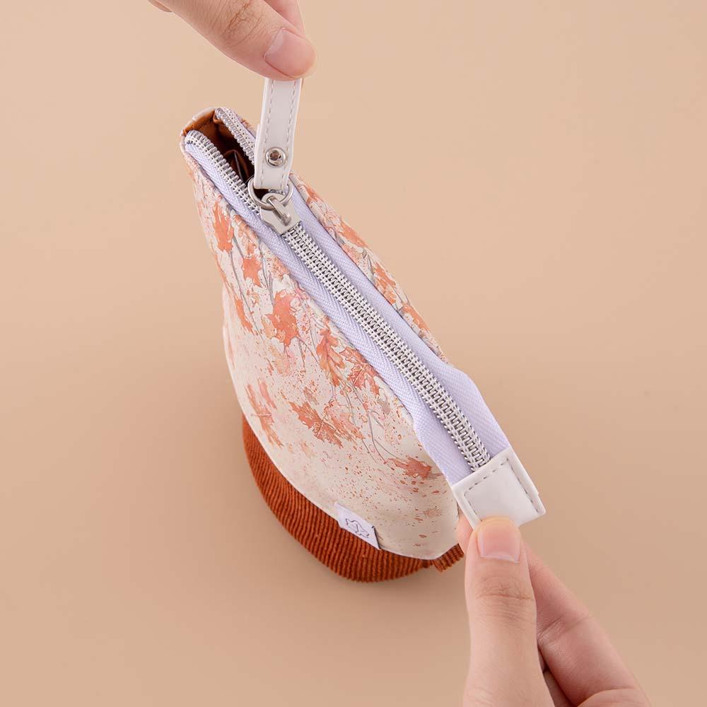 Tsuki ‘Maple Dreams’ Pop-Up Pencil case in maple with zip top held in hands on beige background