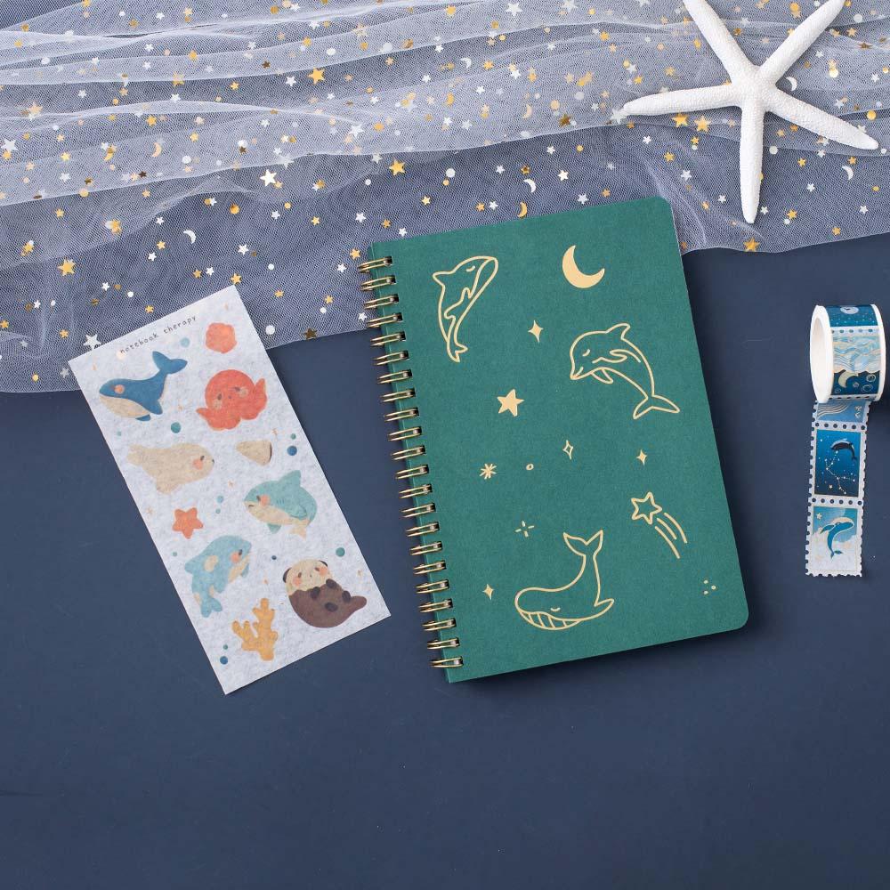 Tsuki Ocean Edition Ring Bound notebooks in aqua blue free with sticker sheet and Ocean washi tape and starfish on dark blue background