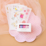 Tsuki Floral collection, washi tapes in boxed packaging and 6 sticker sheet laid out on peach background