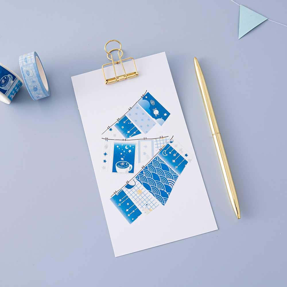 Tsuki ‘Cup of Galaxy’ Washi Tape Set on clipboard with gold pen on light blue background