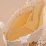 Zippable inside pocket of Tsuki ‘Vintage Kinoko’ Tote Bag on beige background