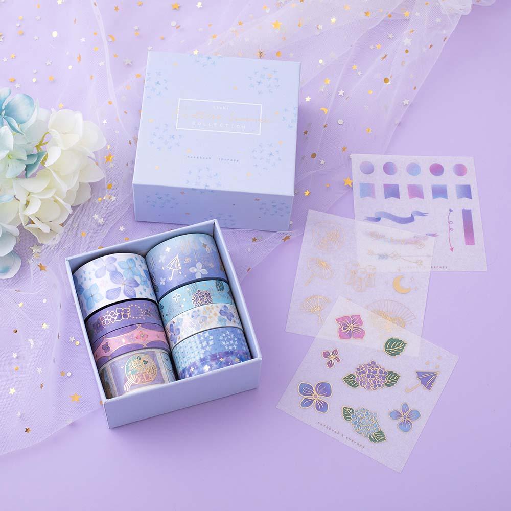 Tsuki Endless Summer Washi Tape Set with free sticker sheets and eco-friendly gift box packaging with white blue hydrangea flowers and sparkly netting on lilac background
