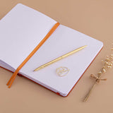Open page spread of Tsuki ‘Kitsune’ Limited Edition Fox Bullet Journal with free paperclip gift with gold pen and dried flowers on beige background