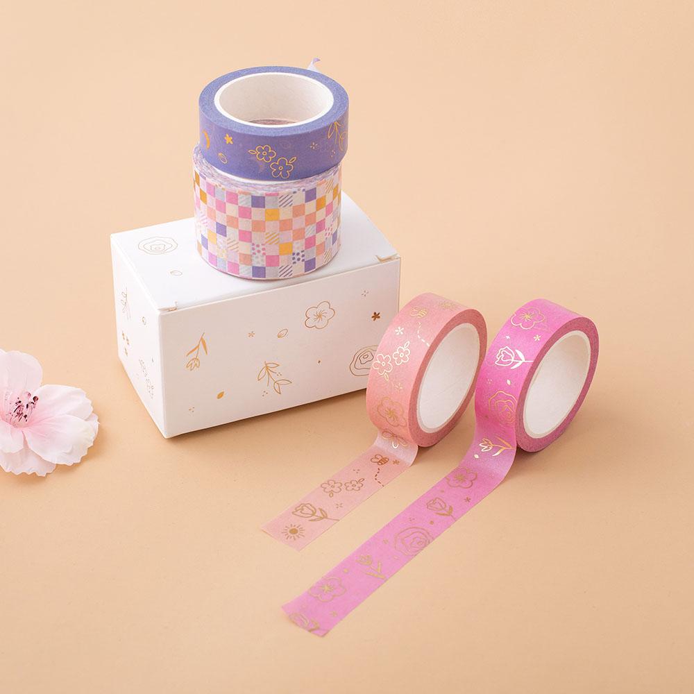 Tsuki Floral washi tapes laid on peach background with boxed packaging