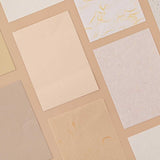 Tsuki Mixed Scrapbook Paper Pack at an angle on beige background