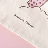 Close up of Tsuki ‘Ichigo’ Boba Tote Bag matcha design with Notebook Therapy logo on light pink background