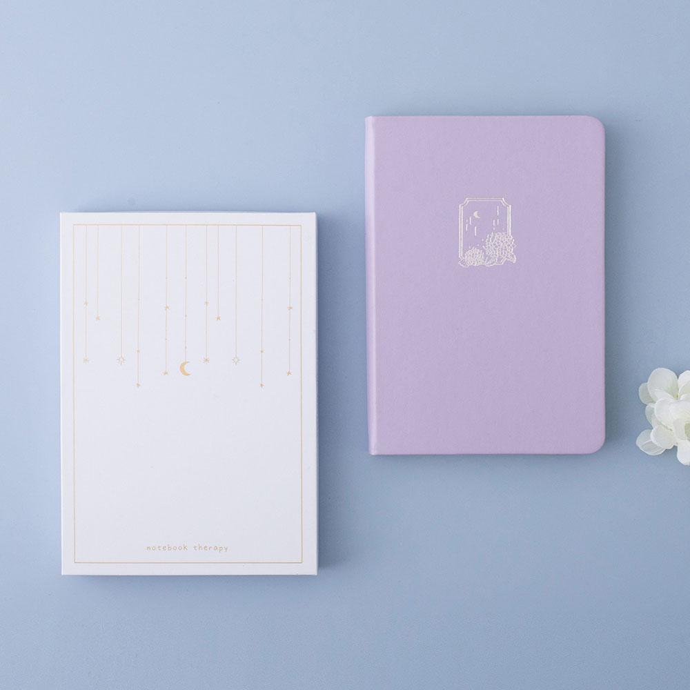 Tsuki Endless Summer Limited Edition Bullet Journal in Lilac Bloom with eco-friendly gift box packaging and white hydrangea flowers on light blue background