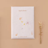 Tsuki Handmade Petal Paper Pack in glassine envelope packaging with dried flowers on beige background