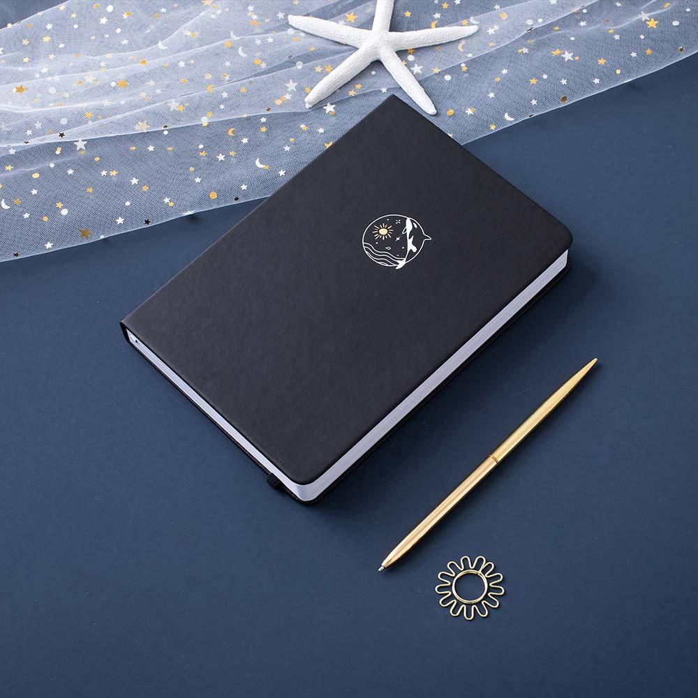 Tsuki deep black Playful Orca limited edition notebook with gold pen and starfish and free sunshine gift on dark blue background