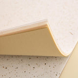 Close up of Tsuki Mixed Scrapbook Paper Pack corners on cream background