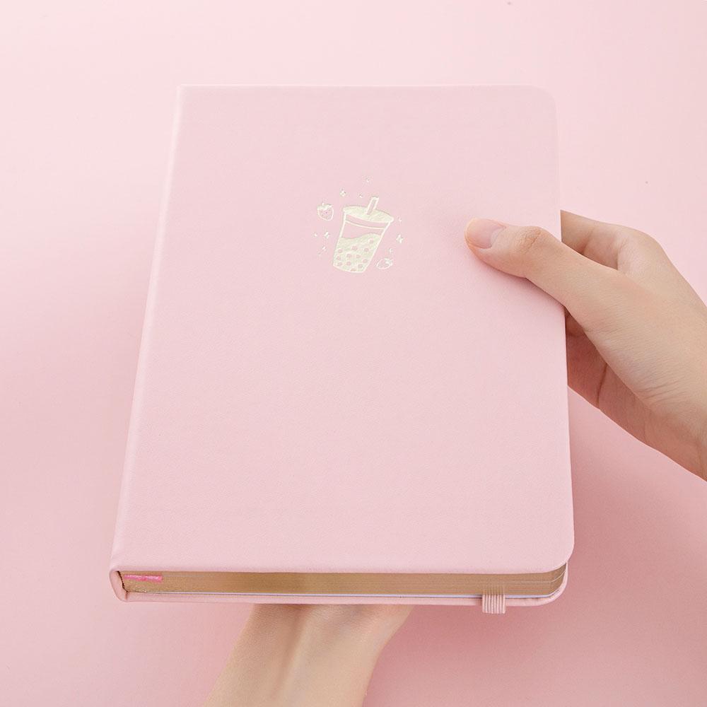 Tsuki ‘Ichigo’ Limited Edition Boba Bullet Journal held in hands at an angle in light pink background