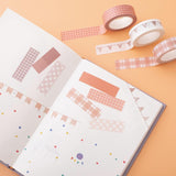 Tsuki Core Washi Tape Set in Warm Neutral on open bullet journal page with flowers on orange peach background
