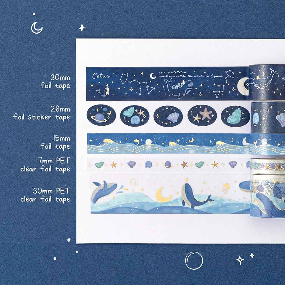 Swatch of the tsuki Gentle Giant washi tape set on white paper against a blue background 