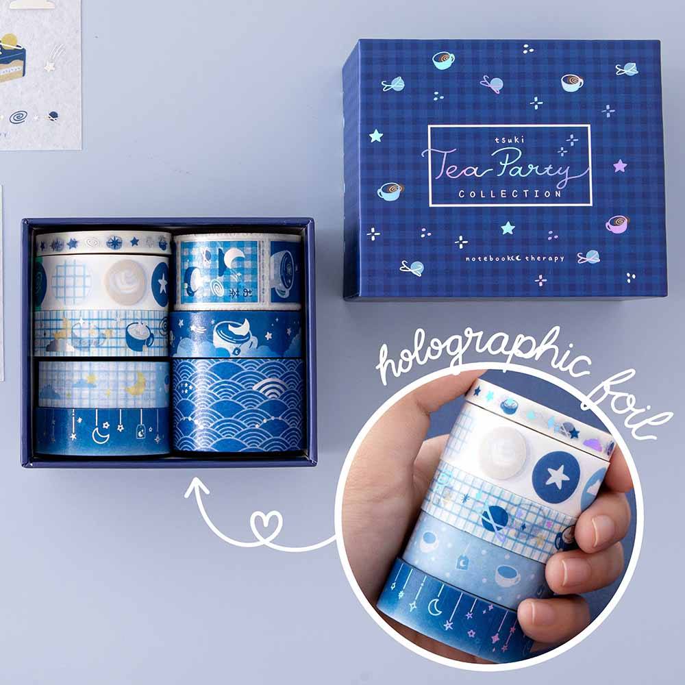 Close up of Tsuki ‘Cup of Galaxy’ Washi Tape Set with free sticker sheets on light blue background