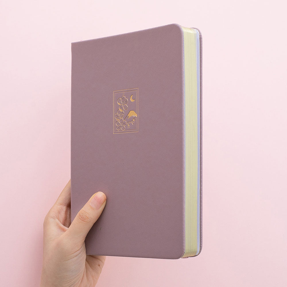 Tsuki 'Sakura' Limited Edition Bullet Journal in blush pink held in hands in light pink background