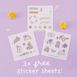 Three free stickers sheets from Tsuki Bunny Blush Washi Tape Set designed with Blossom Bujo with felt flowers on lilac background