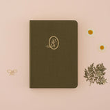 Tsuki Mori Green linen Bullet Journal notebook with plant design on beige background with dried flowers around