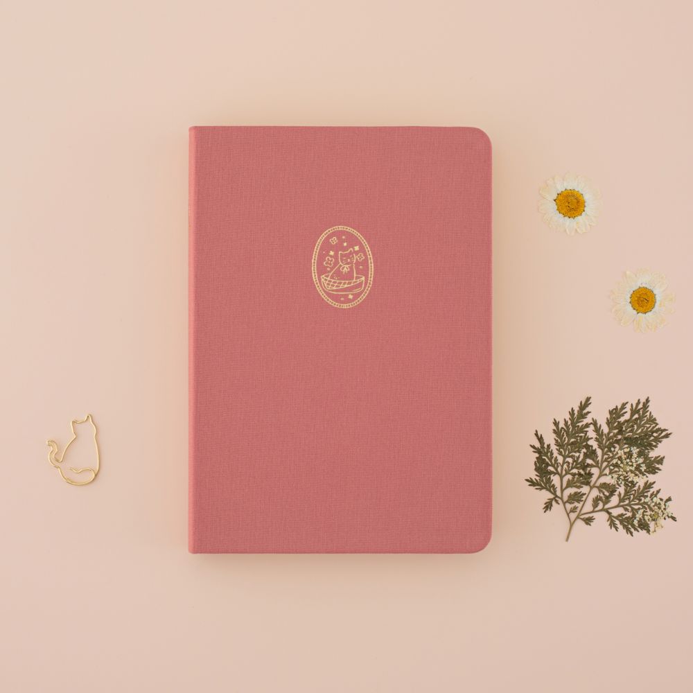Tsuki Neko Neko Pink Linen Cat Bullet Journal notebook on a beige background with dried flowers around